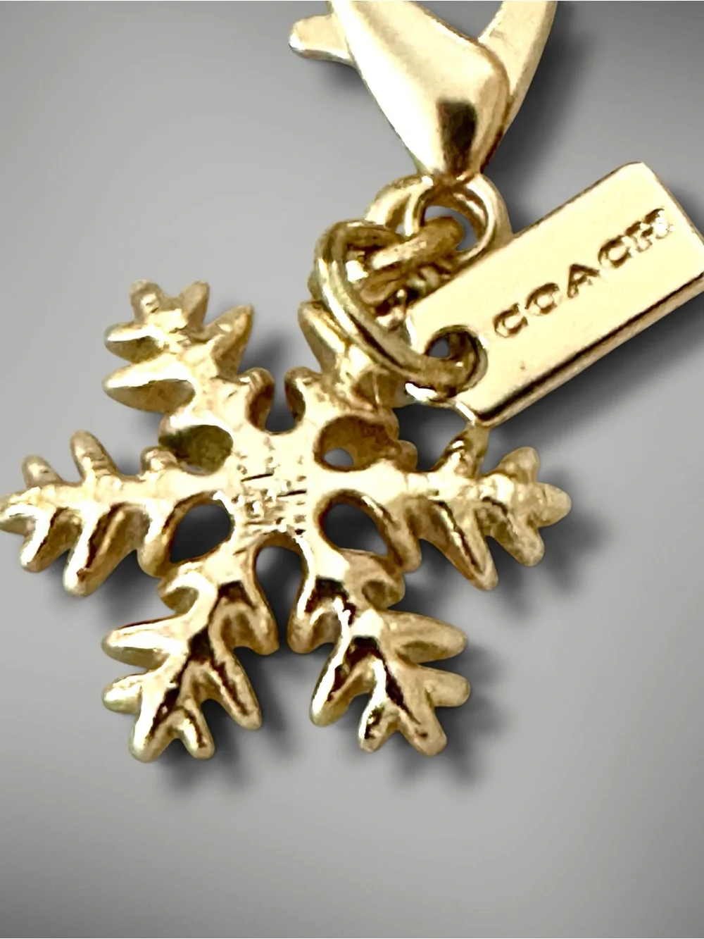 Coach Gold-Tone Snowflake Bag Charm with Logo Branded Tag - Collectible Gift